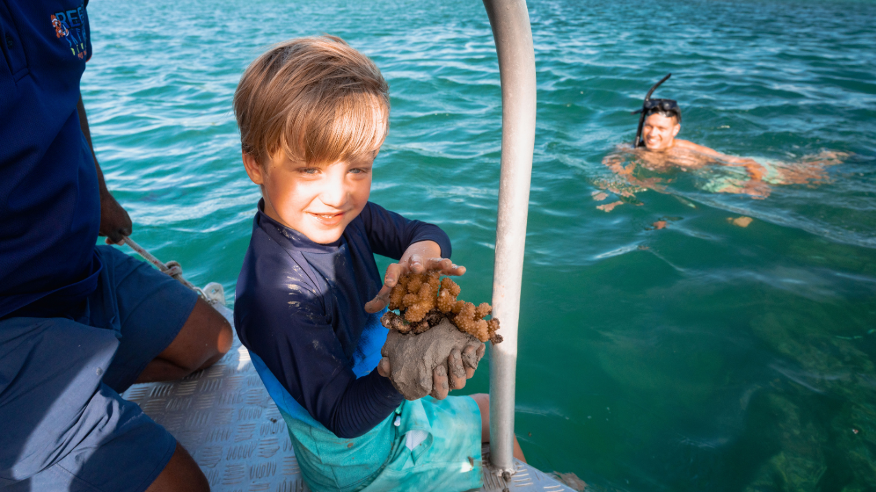A Boy Holding A Stuffed Animal In A Boat
